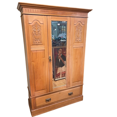 382 - Victorian walnut mirror door wardrobe with base drawer, 193cm by 125cm by 46cm.