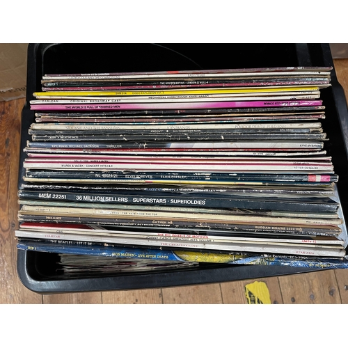 48 - Four boxes of LP and single records including Bruce Springsteen, Queen, etc.