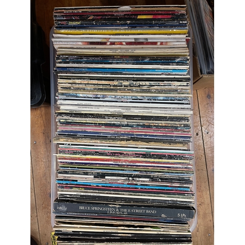 48 - Four boxes of LP and single records including Bruce Springsteen, Queen, etc.