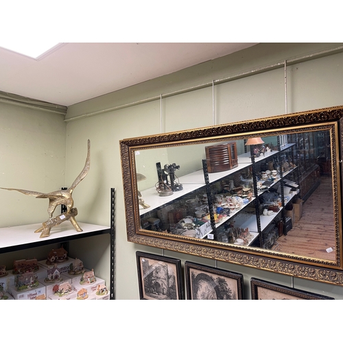 72 - Rectangular gilt framed wall mirror and brass eagle on branch.