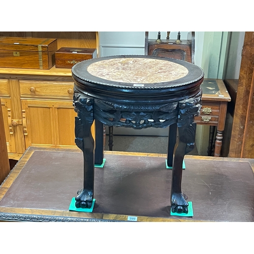 398 - Oriental carved hardwood jardiniere stand with inset marble top, 47cm by 46cm diameter.