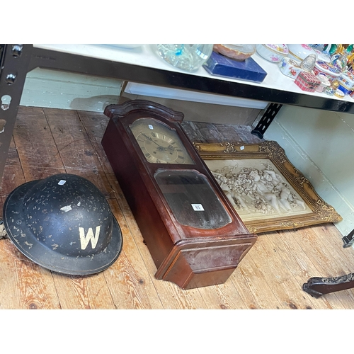 85 - Wall clock, Warden's 'W' helmet and a framed ornate cupid wall plaque.