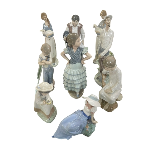 17 - Seven Lladro and two Nao figures.