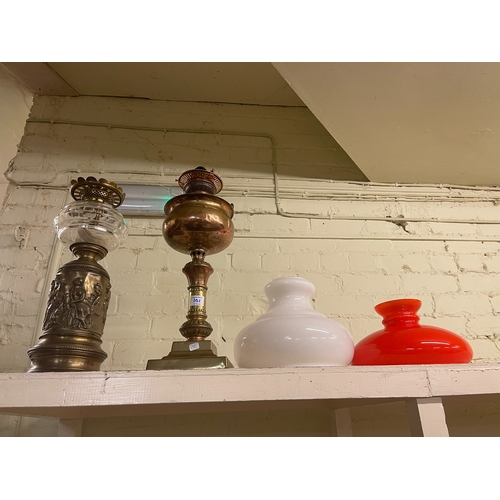 101 - Two Victorian ornate oil lamps together with various glass shades.