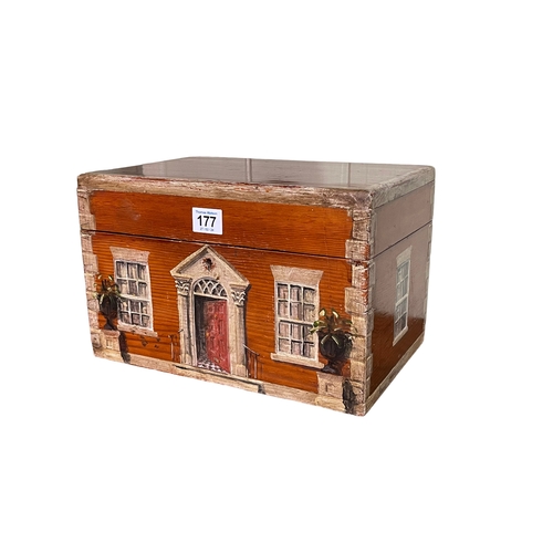 177 - Painted pine box depicting front and two sides of a house, 31cm by 20cm by 20cm.