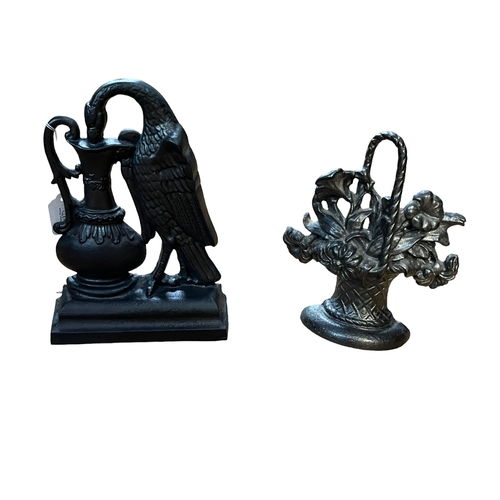 60 - Two cast metal door stops, 28cm and 25cm high.