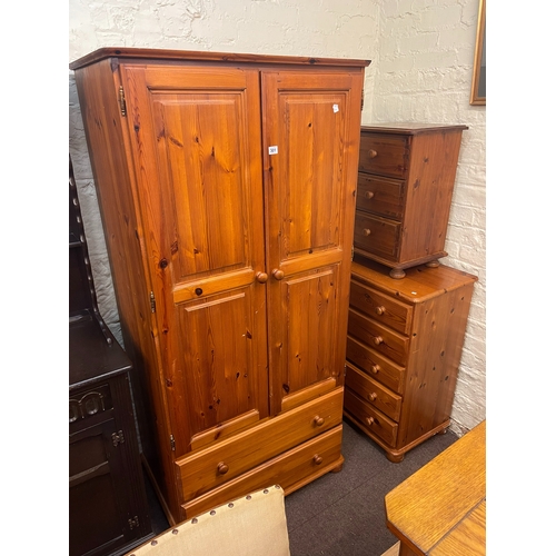 301 - Pine three piece bedroom suite comprising double door wardrobe with two base drawers, five drawer ch... 