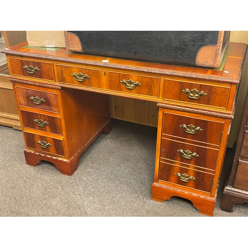 310 - Yew six drawer pedestal desk, 77cm by 122cm by 62cm.