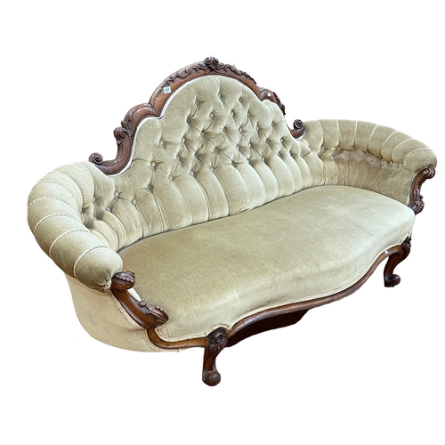 337 - Victorian walnut framed arched back settee with serpentine front seat in buttoned draylon.