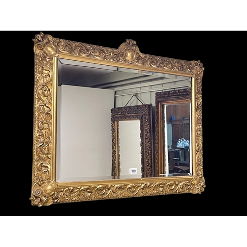 379 - Rectangular gilt framed bevelled wall mirror, 68cm by 85cm.