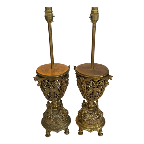 142 - Pair of ornate gilt metal table lamps with dragon decoration, 56cm.