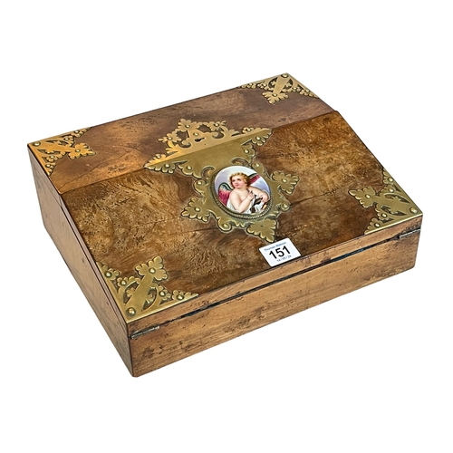 151 - Ornate Victorian walnut and brass mounted writing slope with porcelain cherub insert, 30cm by 11cm.
