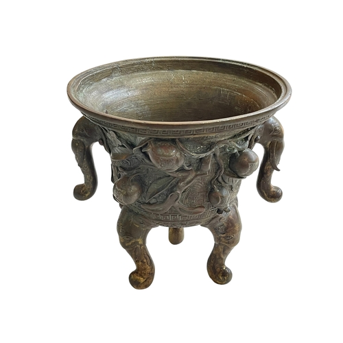 162 - Antique Chinese/Eastern bronze three footed vase decorated with elephant and floral design, 24cm.