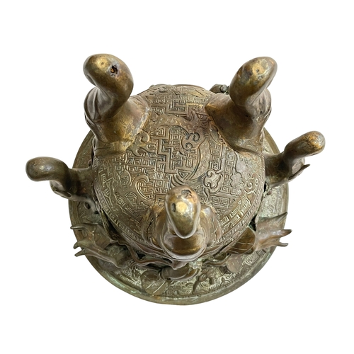 162 - Antique Chinese/Eastern bronze three footed vase decorated with elephant and floral design, 24cm.