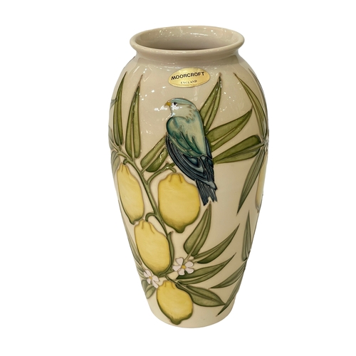 184 - Sally Tuffin for Moorcroft, Lemon Tree and Bluebird vase on ivory ground, 25.5cm.