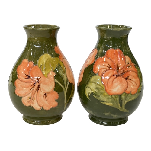 187 - Pair of Moorcroft bulbous vases decorated with hibiscus on green ground, each 19.5cm