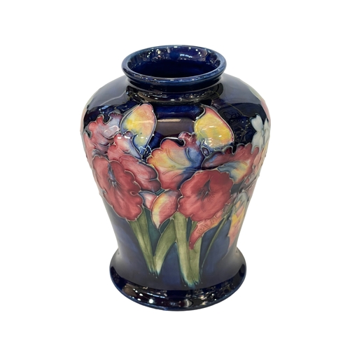 190 - Small Moorcroft vase decorated with Orchid Design on blue ground, 13cm.