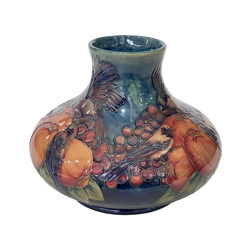 192 - Sally Tuffin for Moorcroft, Finches & Berries squat vase on blue ground, 20cm.