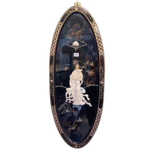 217 - Pair Oriental oval black lacquered plaques with applied figure decoration, 91.5cm by 35.5cm.