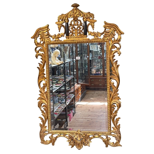 259 - Chippendale style gilt framed bevelled wall mirror, 121cm by 78cm.