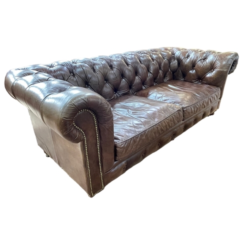 262 - Barker & Stonehouse Halo brown buttoned leather and brass studded three seater Chesterfield settee, ... 