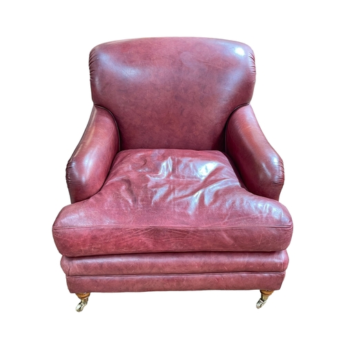 263 - Howard style red leather and studded armchair, 80cm by 88cm by 101cm.