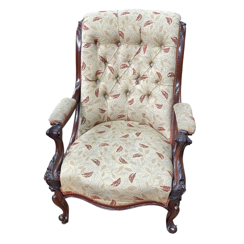 265 - Victorian mahogany framed open armchair in buttoned leaf pattern fabric.