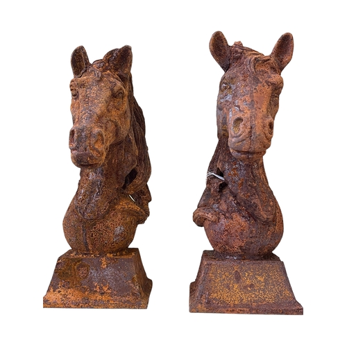 117 - Pair of cast iron horse heads, 47cm high.
