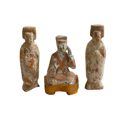 172 - Three Chinese clay figures.