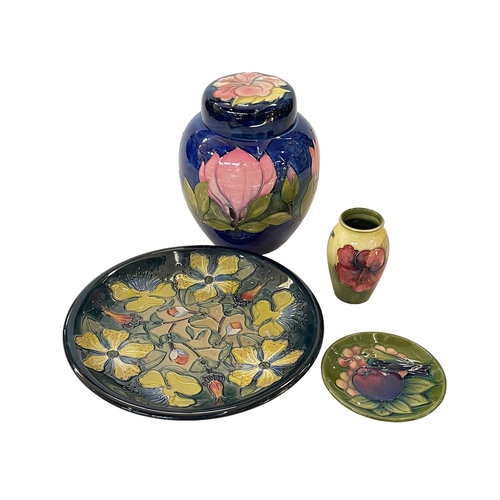 243 - Four pieces of Moorcroft Pottery including Hypericum plate, 26.5cm diameter.