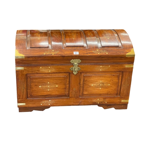 301 - Eastern hardwood and brass inlaid dome top trunk, 49cm by 76cm by 46cm.