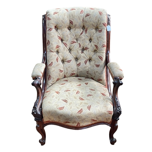 324 - Victorian mahogany framed open armchair in buttoned leaf pattern fabric.