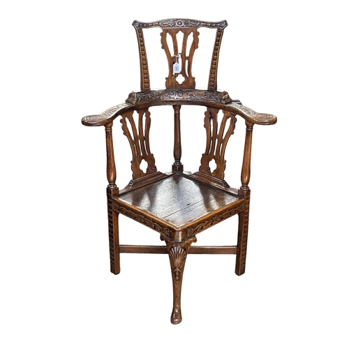 345 - Carved oak Chippendale style high backed corner chair.