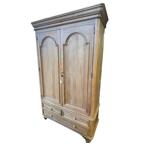 371 - Pine wardrobe having two arched panel doors above two short and one long drawer on turned legs, 215c... 