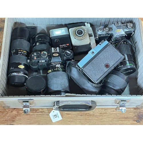 61 - Case of cameras including Nikon with three lenses, Makinon, etc.