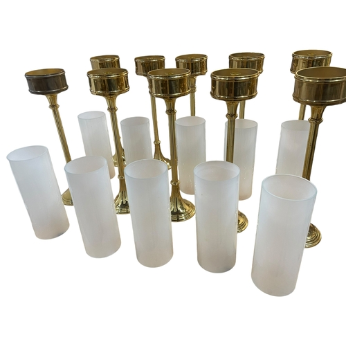 39 - Set of ten brass altar lamps with shades.