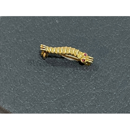 184 - A WWII caterpillar club brooch in gold?, ruby/garnet cabochon set eyes, engraved to the reverse 'P/L... 