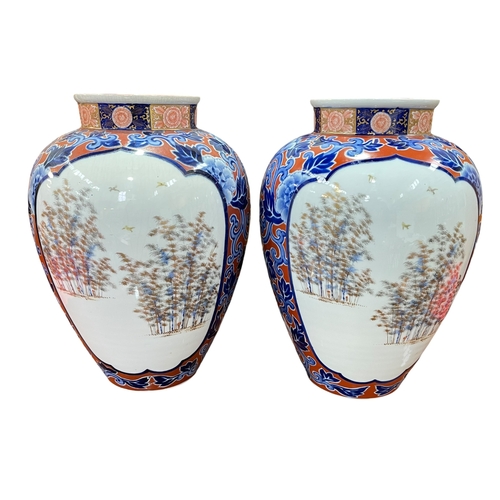 192 - Large pair of Japanese ovoid vases decorated with fish and landscape panels on floral ground, 38.5cm... 