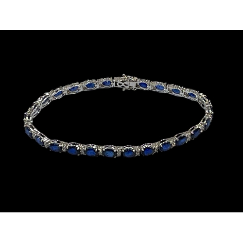 218 - Sapphire and diamond tennis bracelet comprising of 26 oval sapphires, 11.60 carats divided by pairs ... 