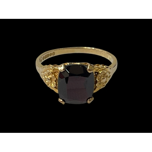 232 - 9 carat yellow gold and single stone garnet ring.