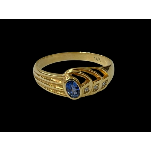 246 - 14 carat yellow gold Ceylon sapphire and three stone diamond ring, size Q.