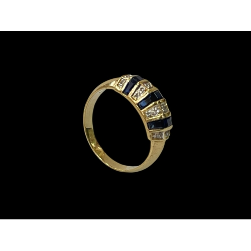 247 - Sapphire and diamond cluster ring set out in rows in yellow gold, size L.