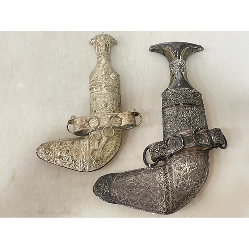 305 - Two silver/white metal mounted Jambiyas, largest 24cm length.