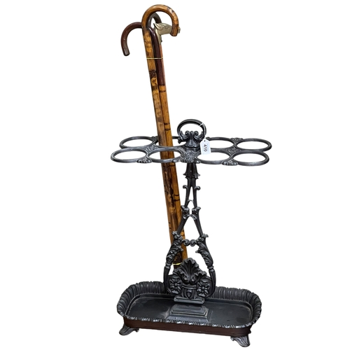 410 - Cast iron eight division stick stand, 68cm by 46.5cm by 26cm, together with a collection of four wal... 