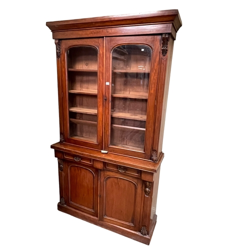 435 - Victorian mahogany cabinet bookcase having two arched glazed panel doors above two drawers with two ... 