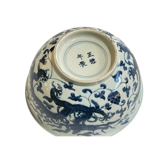 170 - Chinese blue and white dragon bowl, four character marks to base, 18cm diameter.