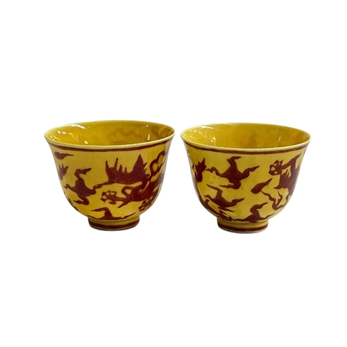 179 - Pair dragon on yellow ground tea bowls, character mark to bases, 4.75cm.