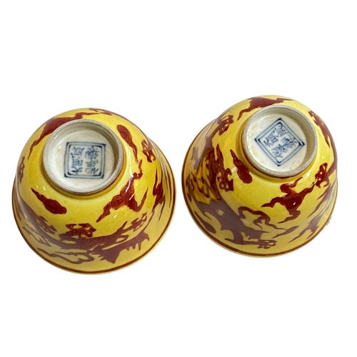 179 - Pair dragon on yellow ground tea bowls, character mark to bases, 4.75cm.