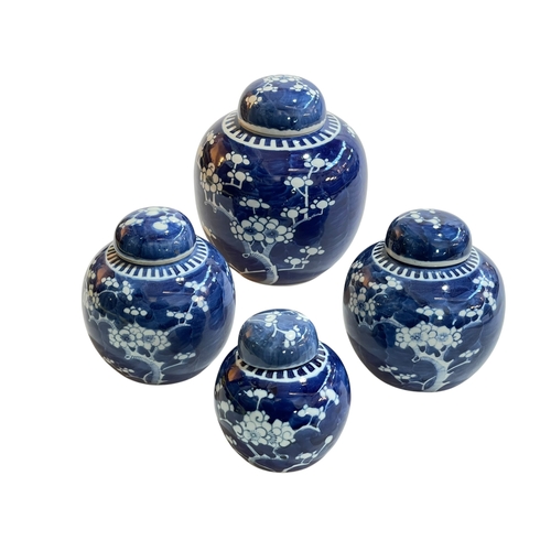 183 - Four Chinese blue and white prunus ginger jars, largest 20cm.