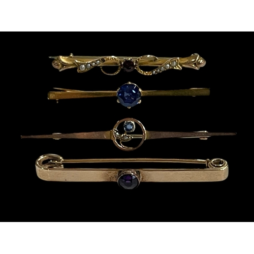 205 - Four gold gem set bar brooches.